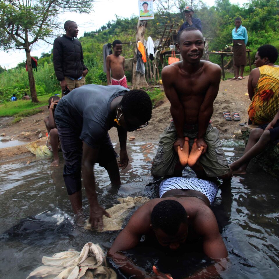A Bakonzo community member receives physical therapy in the healing waters of Kyiriba Kya Thumba hot spring