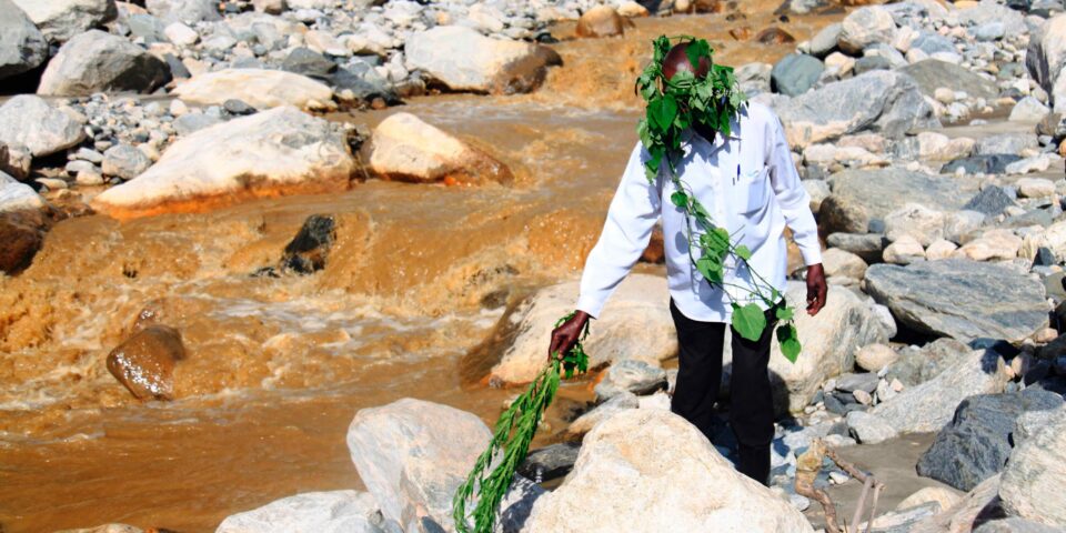 Spiritual leader performs a mountain cleansing ritual at the Nzwiranja-Nyamwamba-Mulyambuli river confluence. Mountain cleansing rituals are performed to the gods before the planting and harvest seasons or when tragedies befall the Bakonzo community