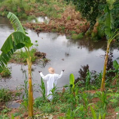 The rising Nile river waters at Wang-lei and the site keeper wearing white robes