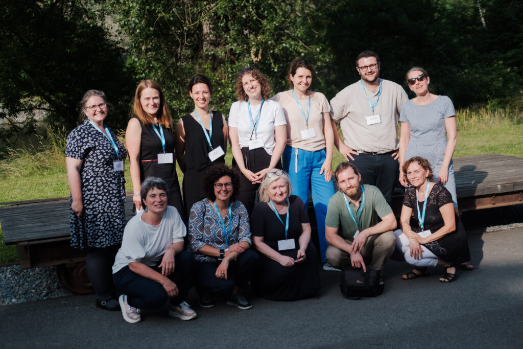 a group of people smiling at the camera at 10 years exchanging ideas event