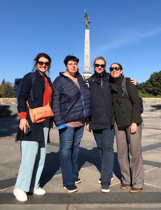 a group of 4 women in front of a monument in Bratislava