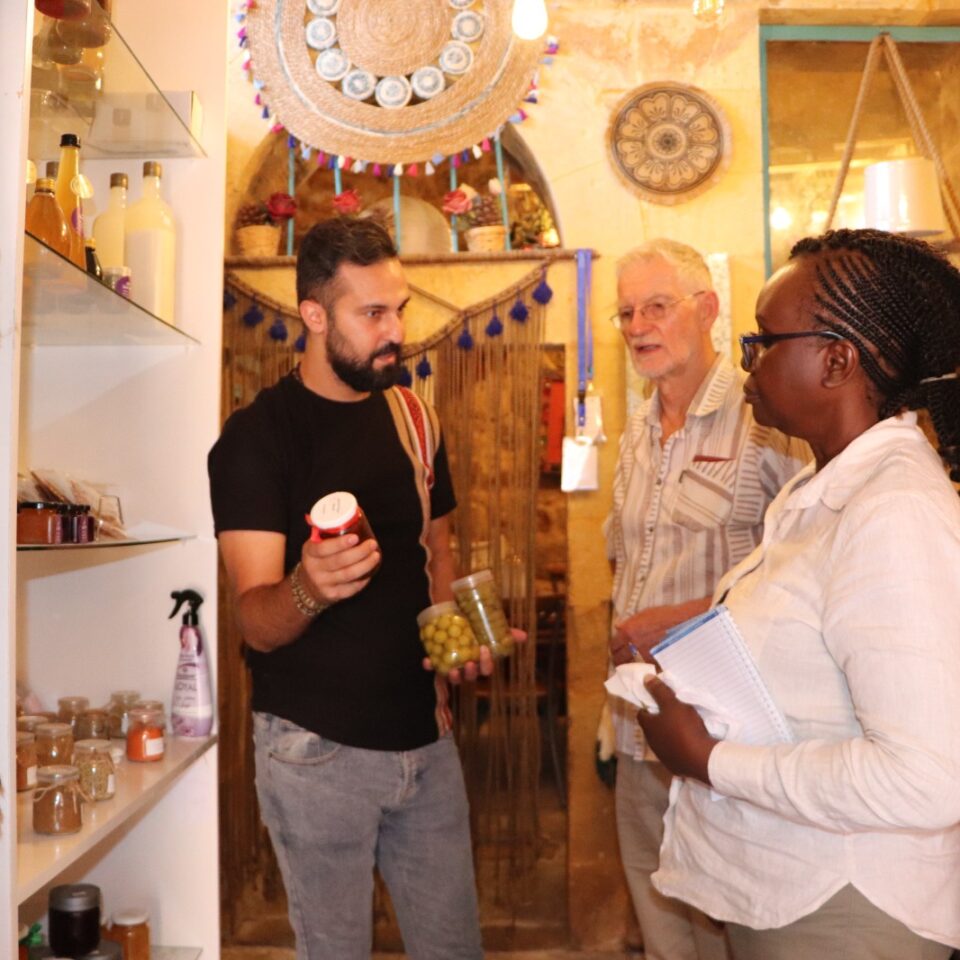 two men and a woman in a shop evaluation visit to As Salt, Jordan