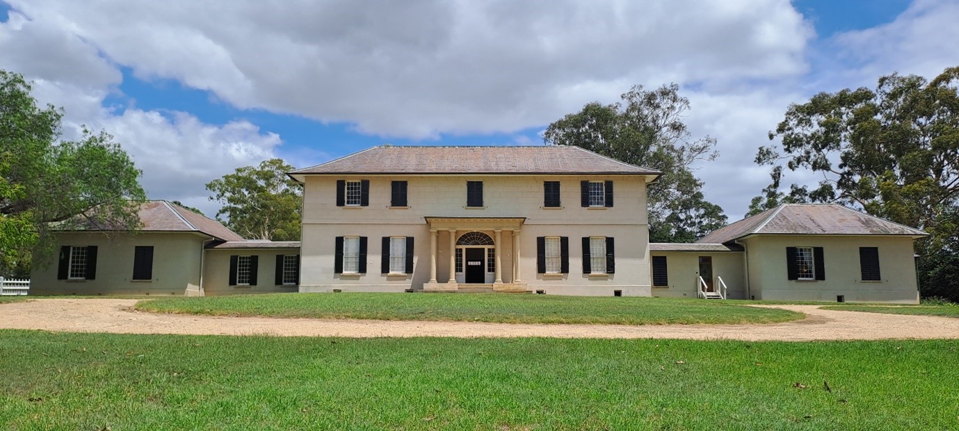 Old Government House, a large white historic building surrounded by green lawns