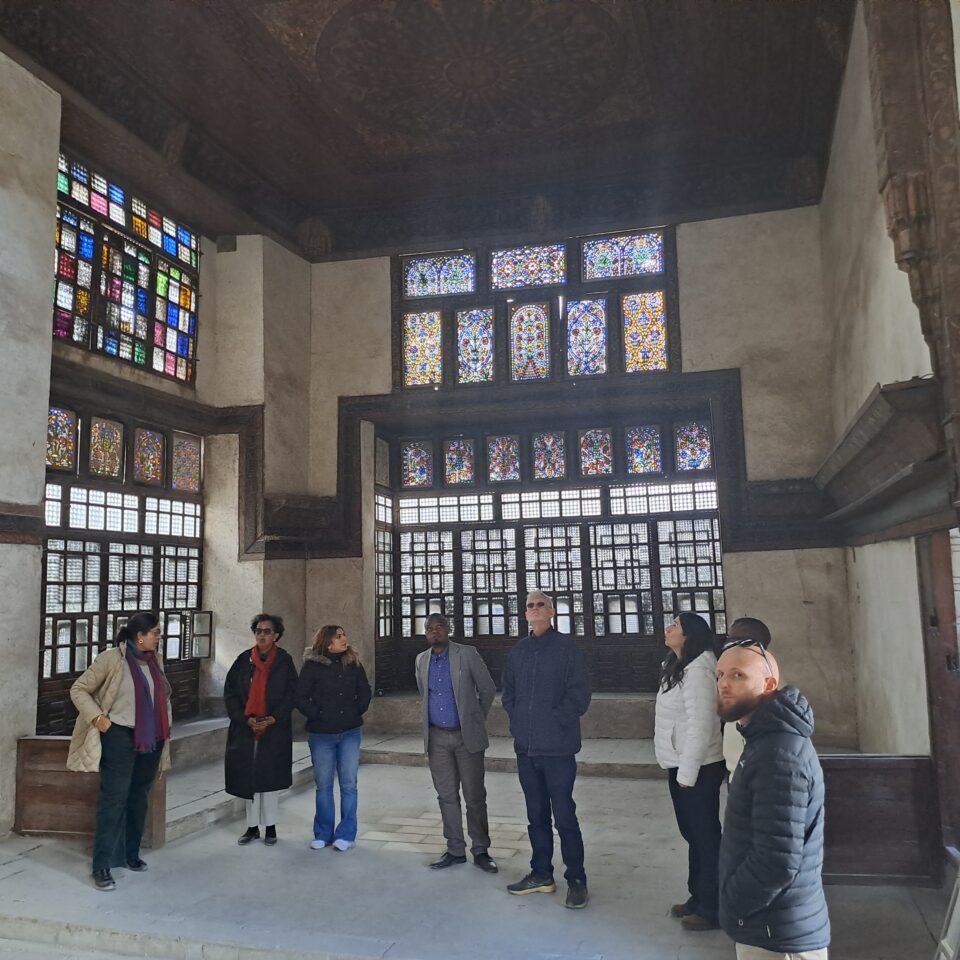A group of people inside Bayt al-Razzaz in Cairo looking at the interior