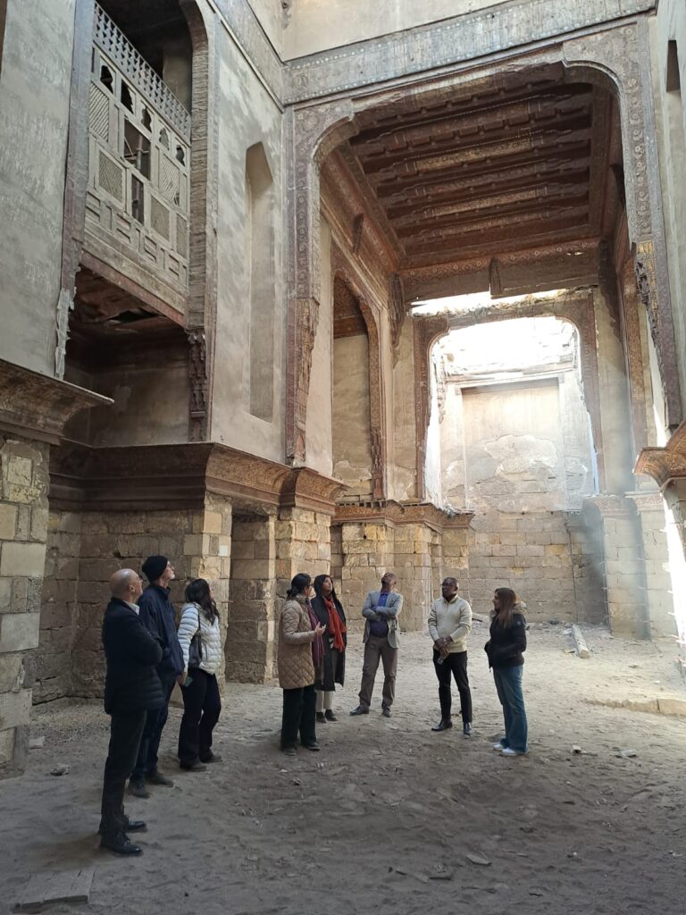 a group of people looking up at ornate ceilings in an historic building in Cairo Egypt