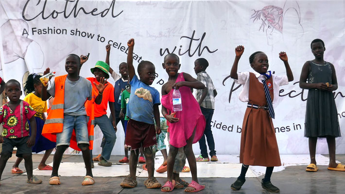 a group of children celebrating with raised arms jerram foundation