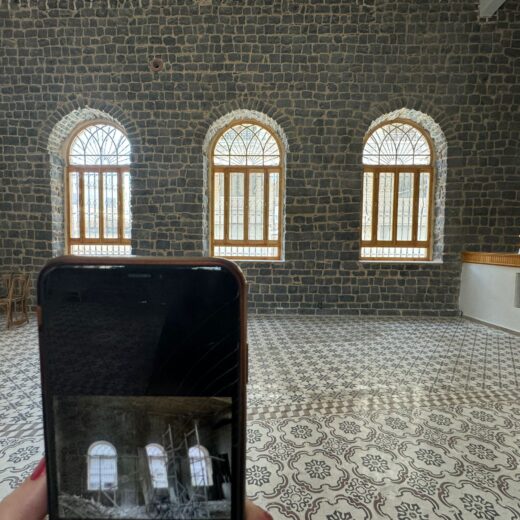 a photo of the interior of a theatre in Homs, Syria with a phone visible in the photo showing the theatre before it was restored with suppport from the Withstanding Change project