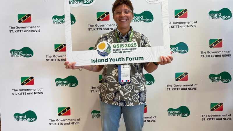 a person holding an Instargam style photo frame at the GSIS conference in St Kitts