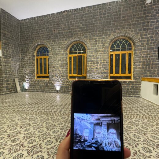 the interior of a theatre with a phone in shot showing what it looked like before restoration, with a climate adaptation focus