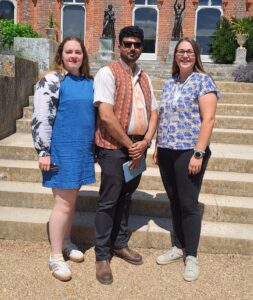 two women and a man in bright sunshine
