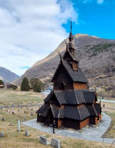 an 11th century stave church in Norway with 4 tiered black wooden roof structures