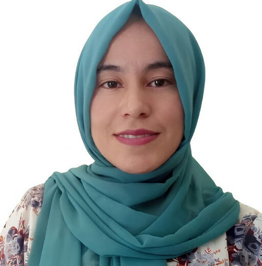 a young woman wearing a turquoise head scarf smiling at the camera