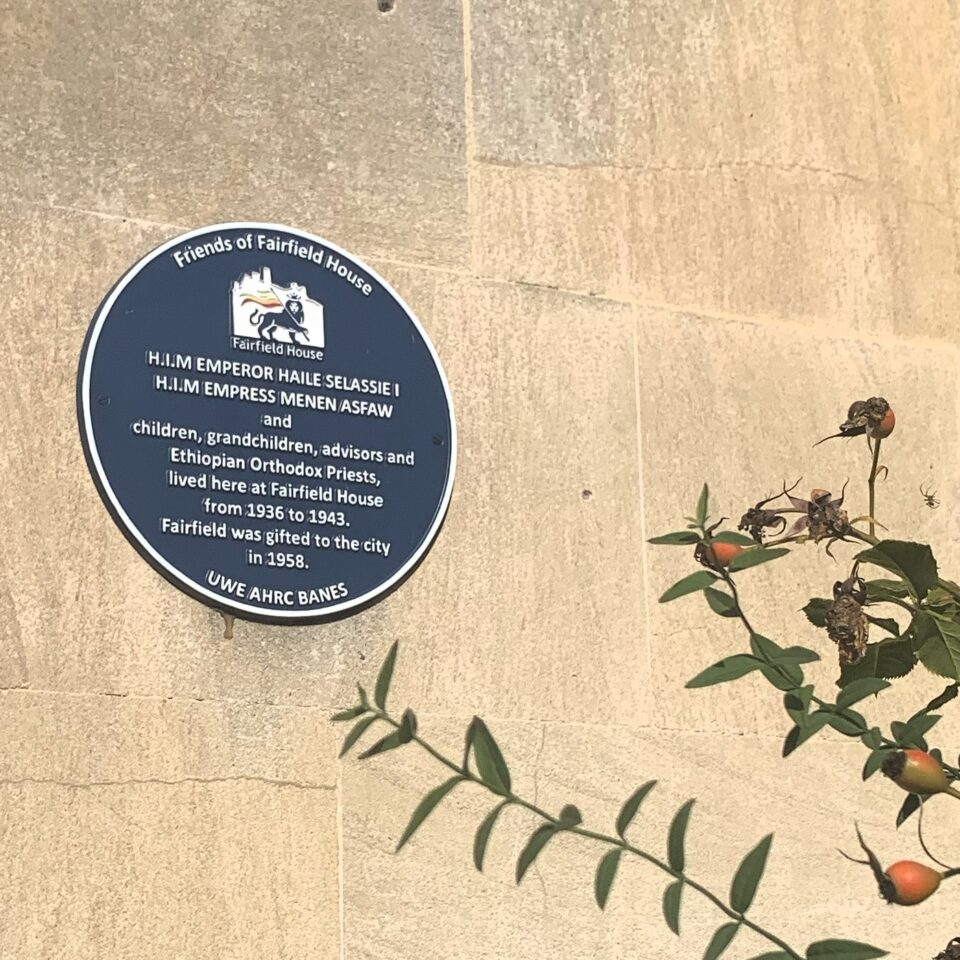 a blue plaque on a stone building which shows that HIM Haillie Selassie lived in this house in Bath, England