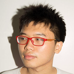 a head shot of a young Thai man wearing red spectacles