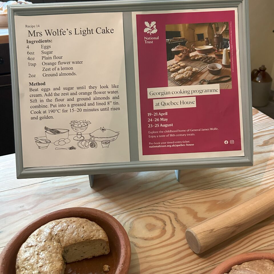 an interpretation panel and kitchen accessories in a National Trust house showing Georgian cooking techniques