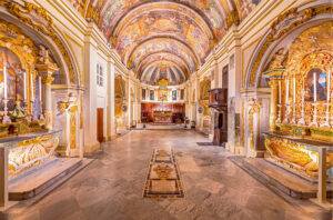a richly decorated church interior in Malta