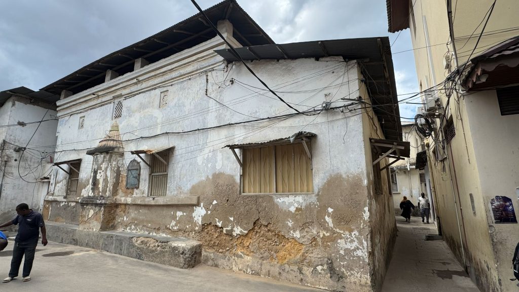 the exterior of the Ba'Mnara Mosque in Zanzibar, showing the effects of salt erosion on the coral stone walls