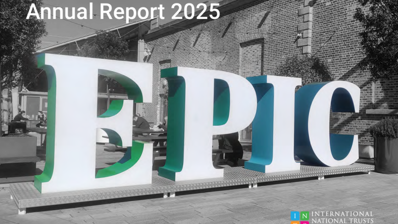 cover of INTO's 2025 annual review with a black and white photo of a building with the word 'EPIC' in 3d in white, blue and green