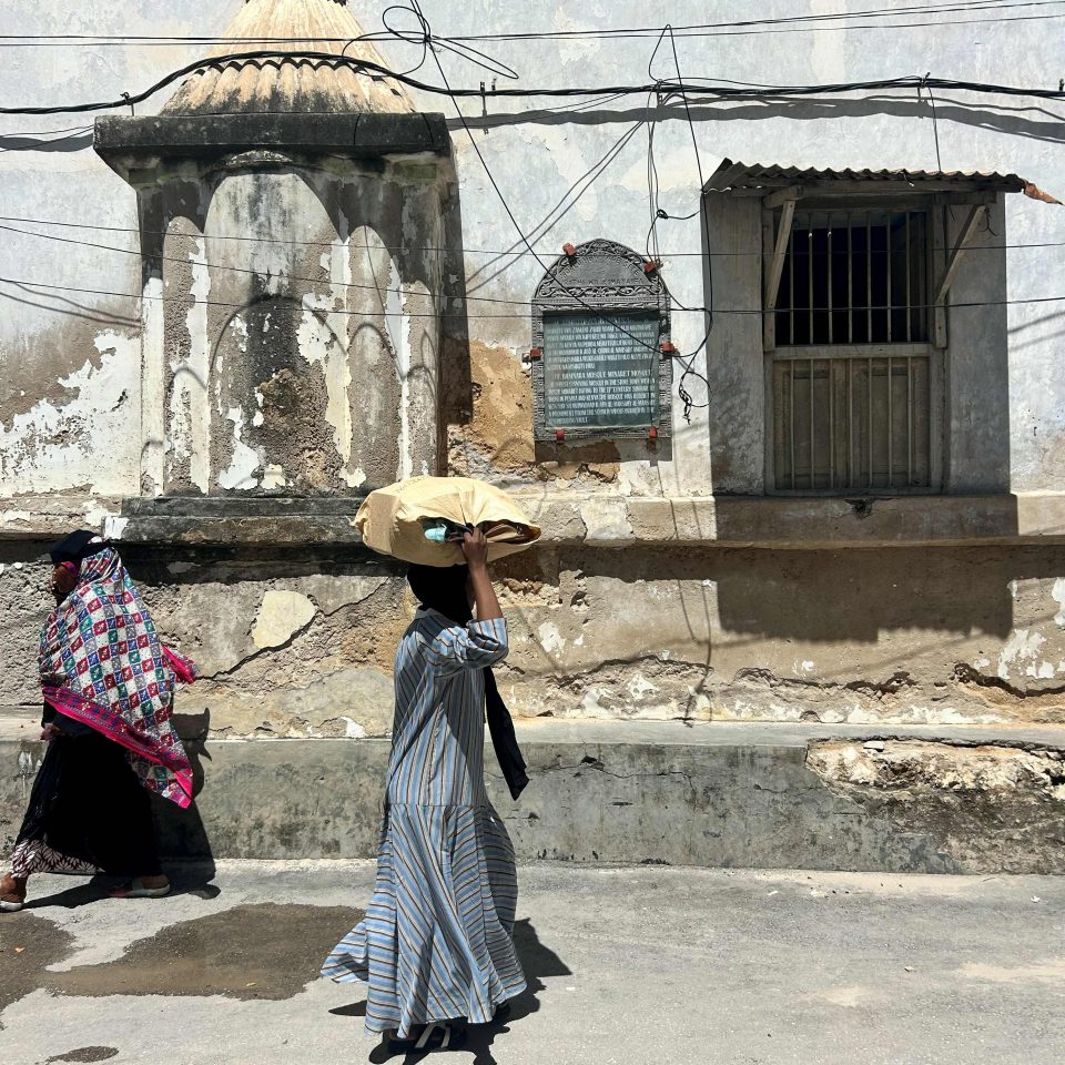 Passers by on the side of the ba'mnara mosque
