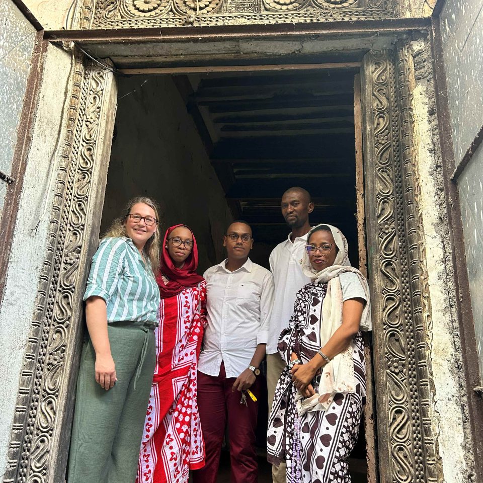 Swaniani Princely House doorway with elaborate carvings - there is a group of people in the doorway