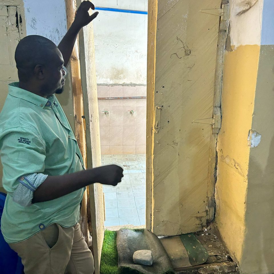 ZSTHS CEO Makame Juma showing the original wooden shutters. The scratch marks in the wood show the handsaw of the traditional wood cutting.