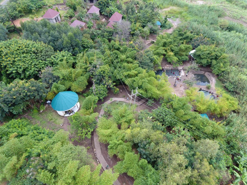 An aerial view of the hot springs site with lush green vegetation